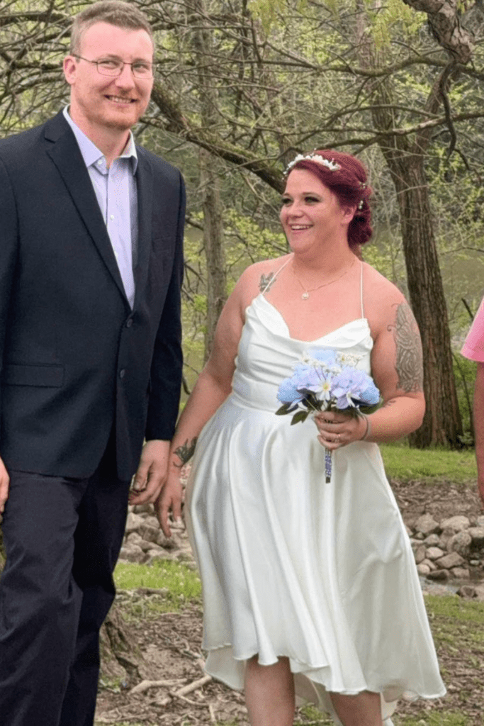 Black tie customs 1 Groom and bride in short white dress with a bouquet of flowers.