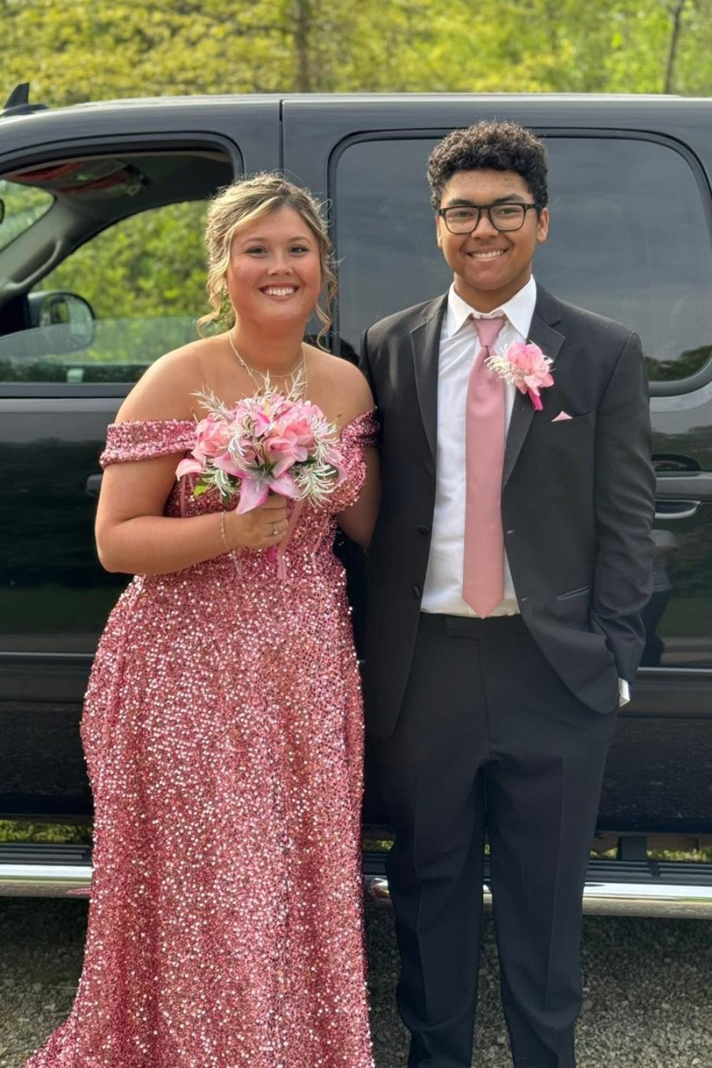 Prom couple with matching pink dress and tie.