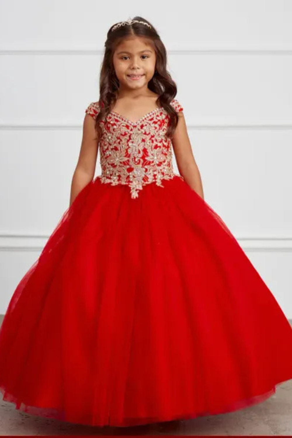 Flower Girl Dresses 2 Young girl in red pageant dress with a tiara in her hair.
