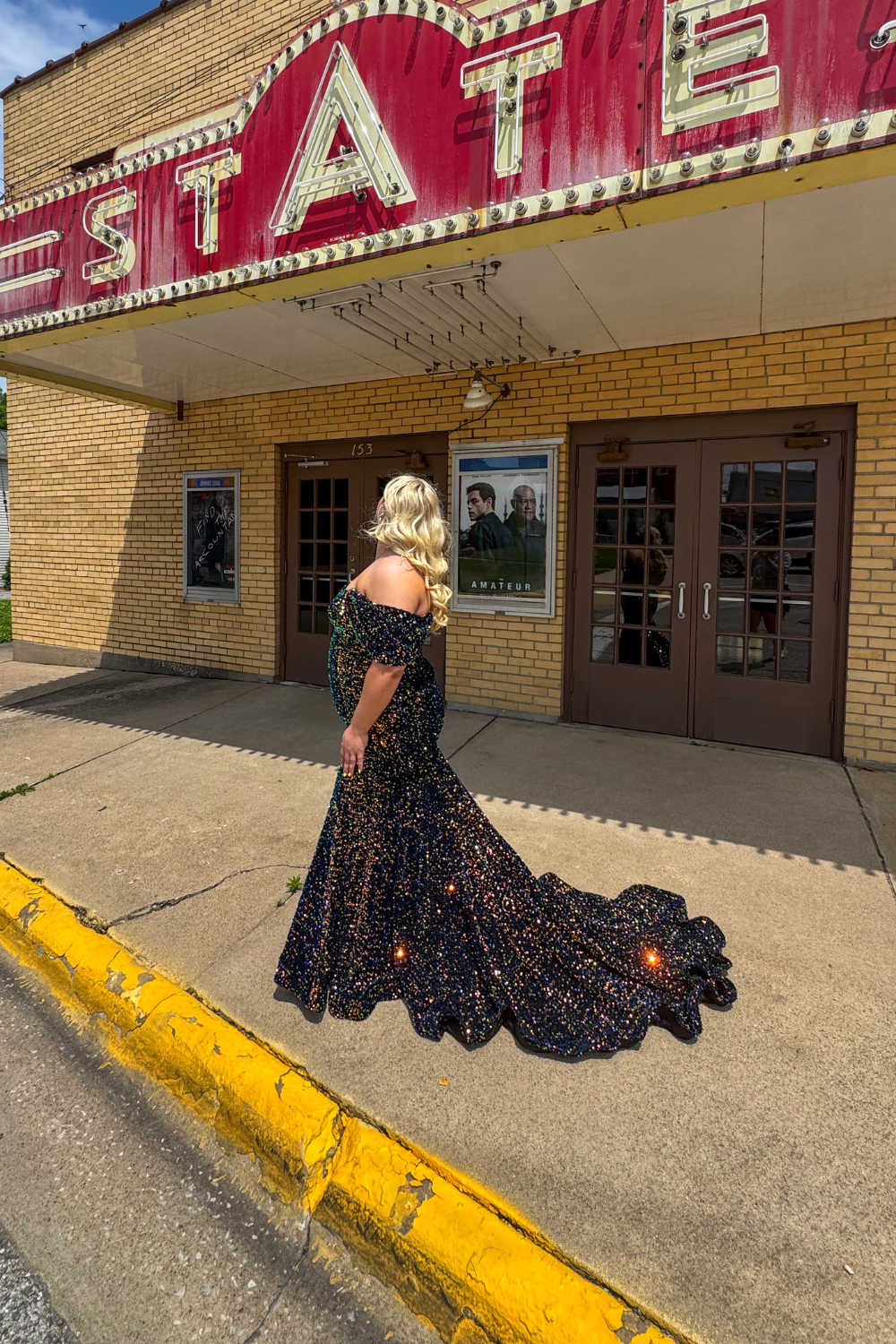 Home 4 Black Tie Affair model with blonde hair and flowing black sequined dress.