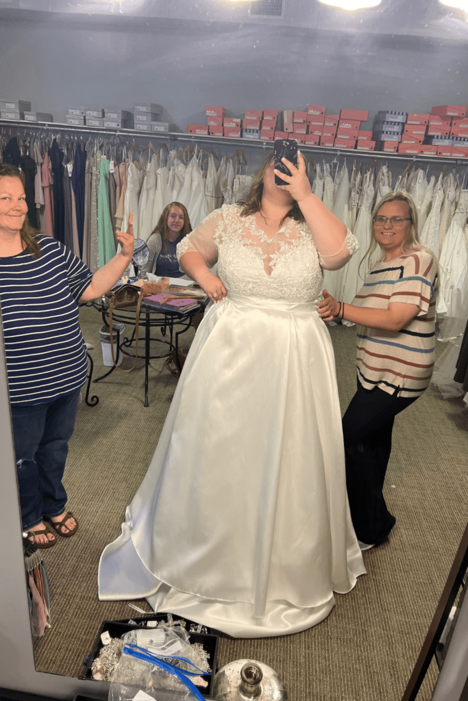 Black tie customs 3 Bride trying on custom gown surrounded by family in Black Tie Affair.